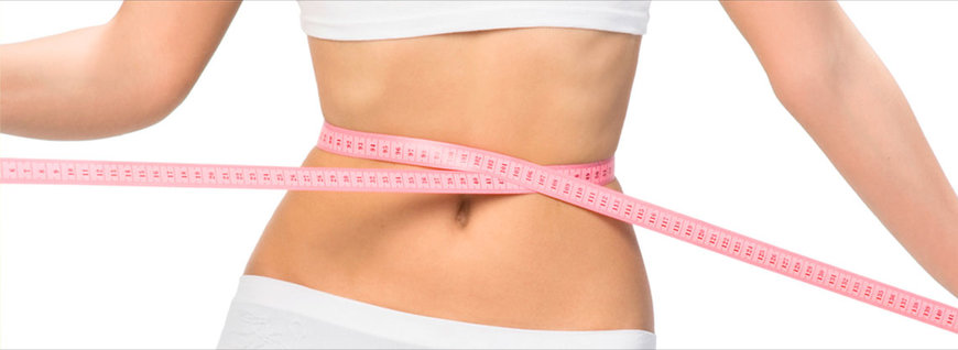 measuring tape shows woman's narrow waist